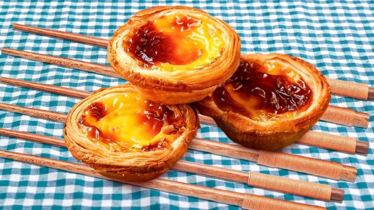 Custard tarts on chopstick cooling rack