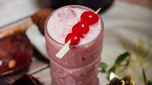 Miami Vice drink garnished with cherries