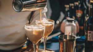 Bartender pouring a cream cocktail.