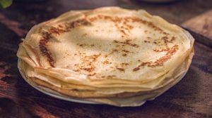 plate of crepes on wood