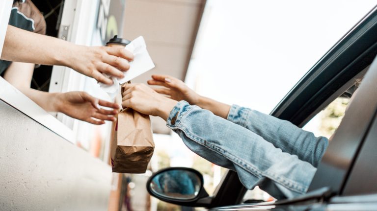 Customer receiving fast food drive-thru order