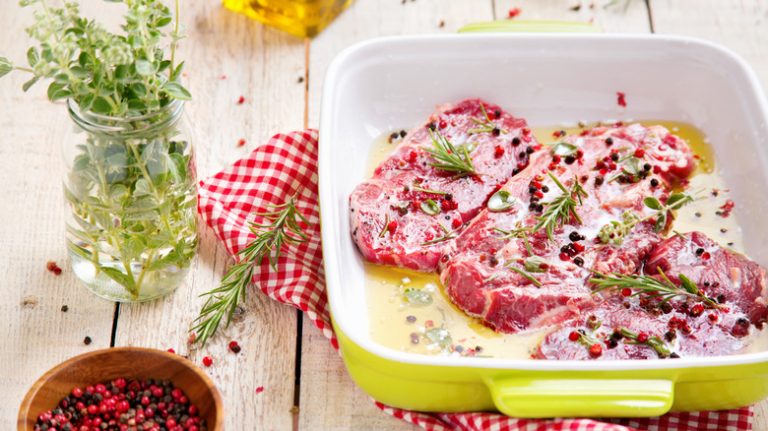 Steaks marinating in a pan