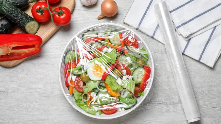 Salad covered with plastic wrap