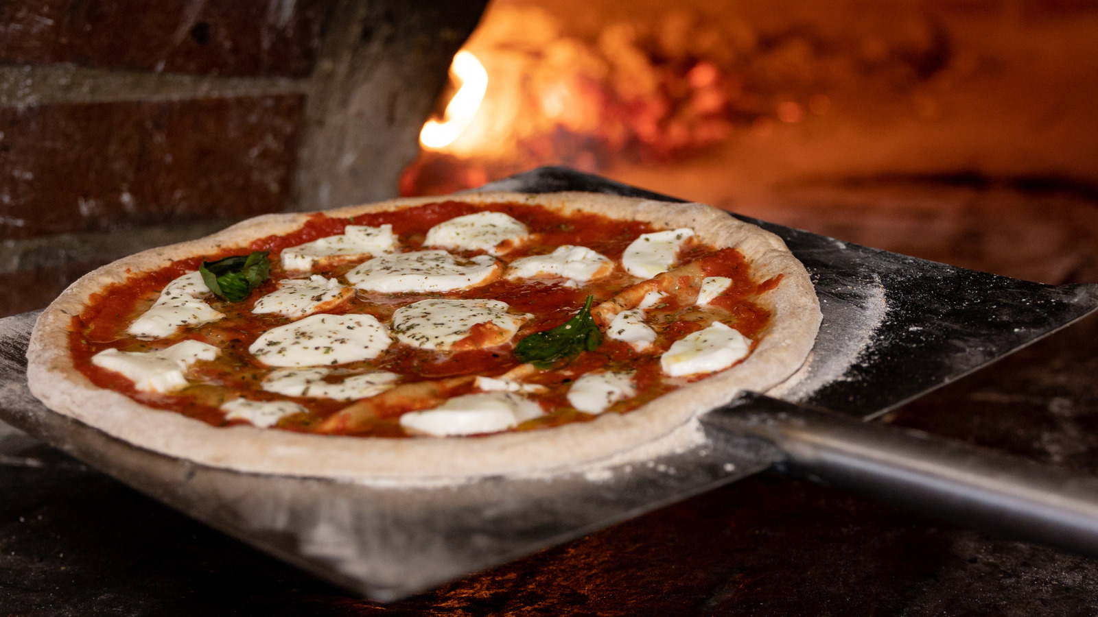 https://www.tastingtable.com/1533420/slide-pizza-peel-oven-trick/